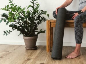 person sat on a bench with a yoga mat