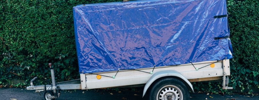 tarp secured onto a trailer with bungee cords
