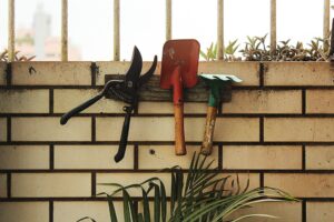 three garden tools being stored upright inside
