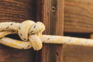 bungee cord knot in front of wooden background