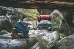 two camping backpacks on top of boulders